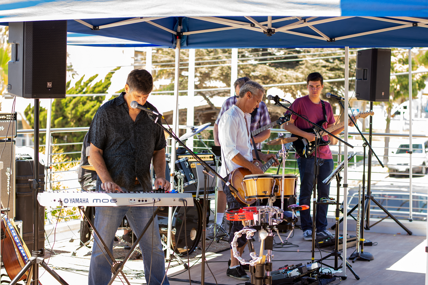 A band of four men playing various instruments.