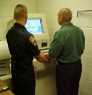 Officer fingerprinting an inmate