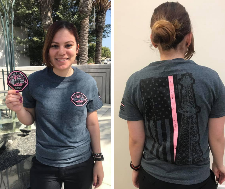 Officer holding patch and modeling gray t-shirt